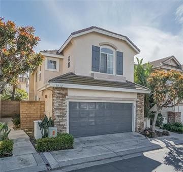 A House With a Grey Garage Door With a Driveway