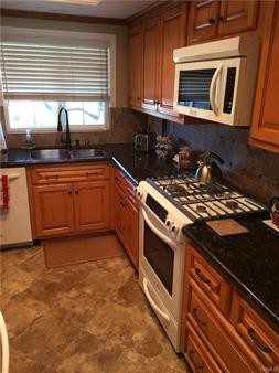 A Black Color Granite Counter for a Kitchen With a Hob