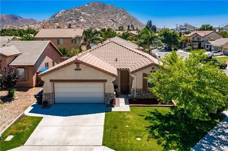 A Home With a Terracotta Roof and a Driveway