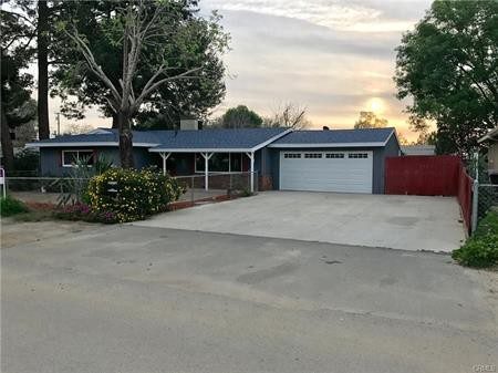 A Blue Color Painted House With a Garage