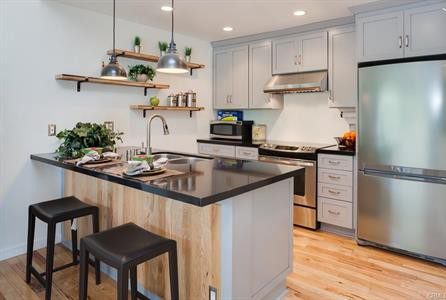 A Kitchen Island With a Black Countertop