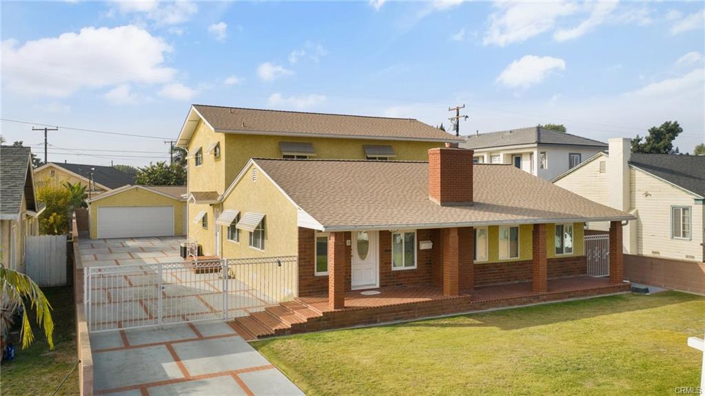 A Yellow and Brown Painted House With a Lawn