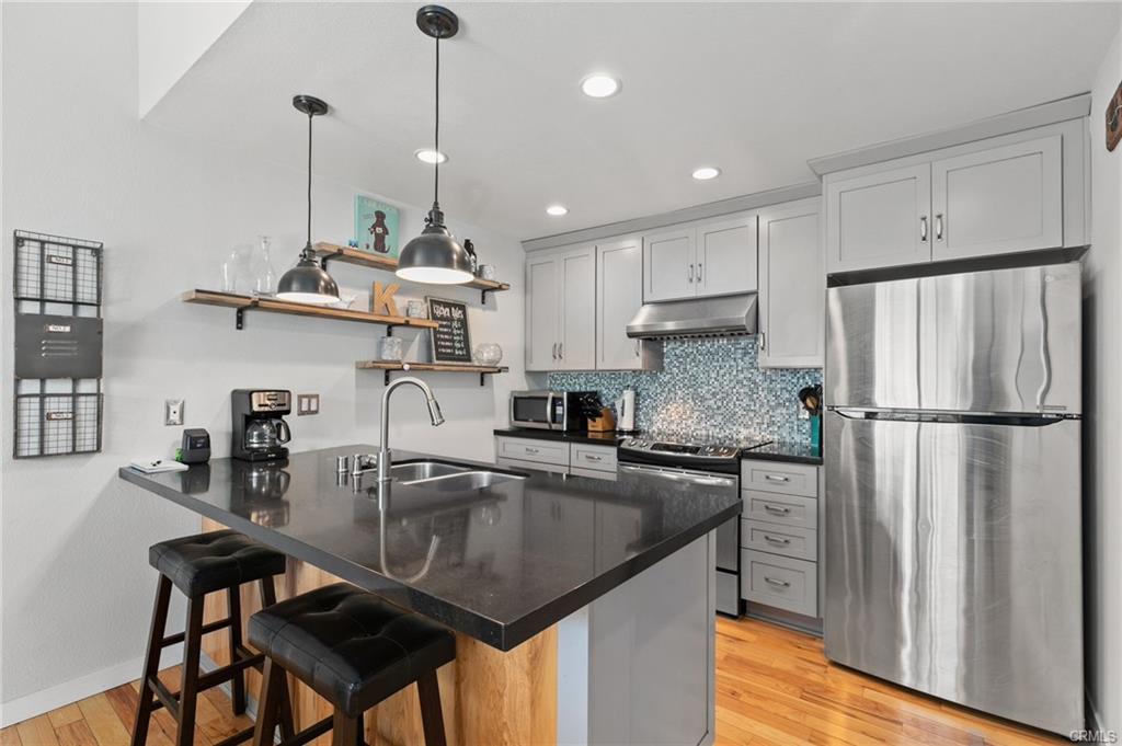 A Stainless Steel Fridge in a Grey Color Kitchen