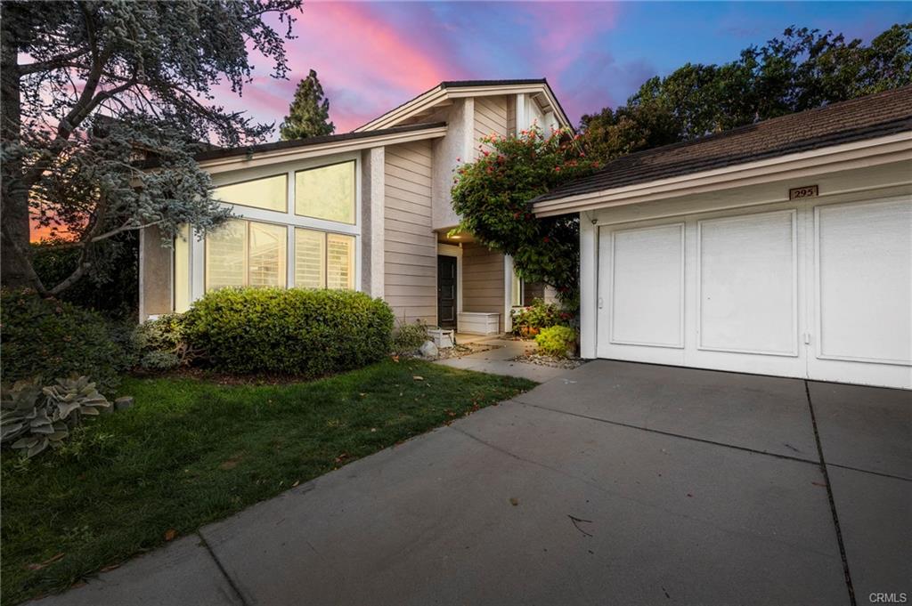 A White Color Garage Door With a Drive Way